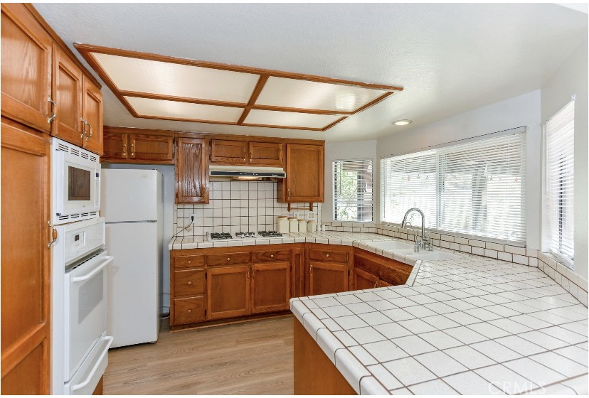 6318 Westview Drive Riverside, CA 92506 - Photo 14 of 17 a kitchen with stainless steel appliances granite countertop a sink and cabinets