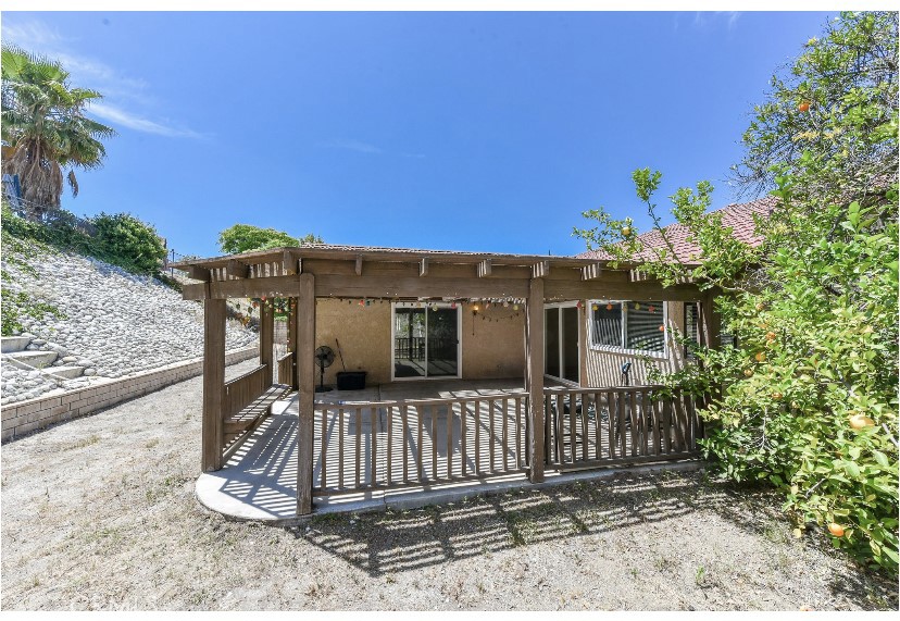 6318 Westview Drive Riverside, CA 92506 - Photo 5 of 17 a view of a house with a small yard and wooden fence
