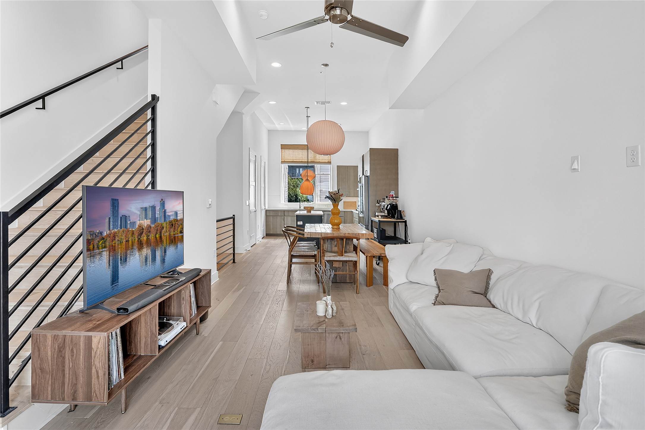2805 McCurdy Street, Unit 14 Austin, TX 78723 - Photo 4 of 40 An open-concept living space with sleek flooring and a contemporary staircase.