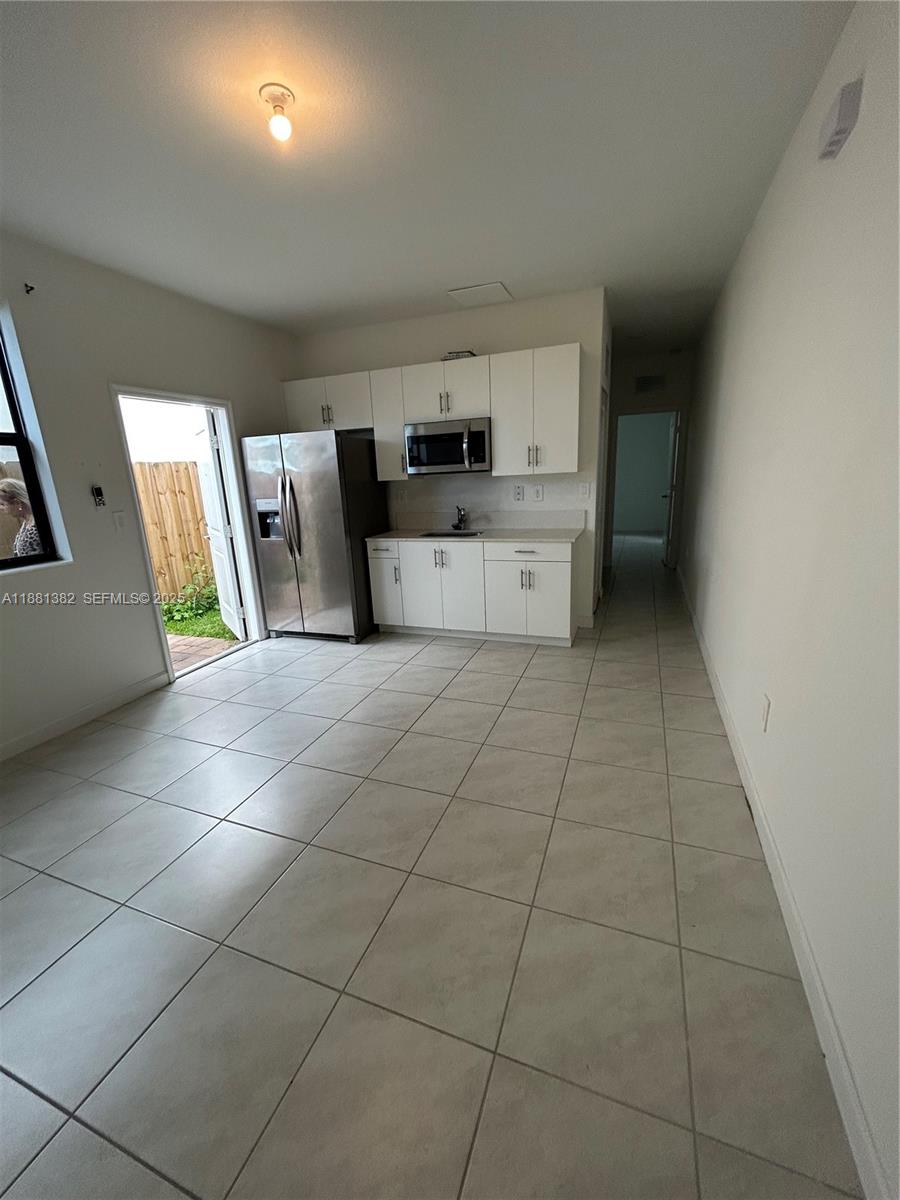 24030 Southwest 119th Place Homestead, FL 33032 - Photo 11 of 15 a kitchen with stainless steel appliances a sink and cabinets