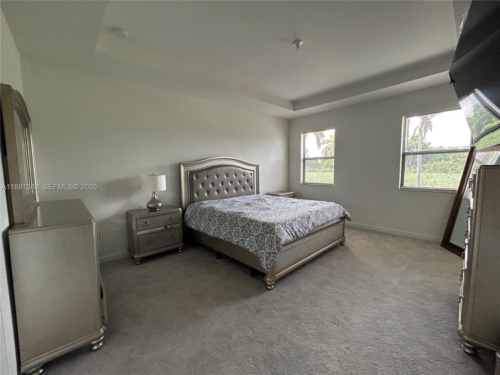 24030 Southwest 119th Place Homestead, FL 33032 - Photo 4 of 15 a bedroom with a bed and a couch