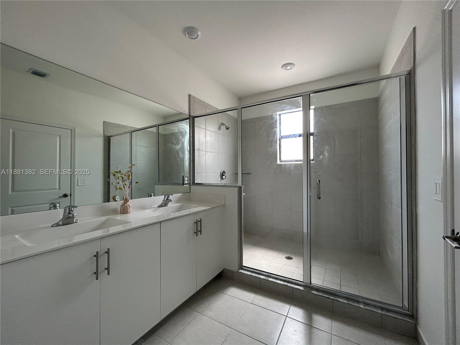 24030 Southwest 119th Place Homestead, FL 33032 - Photo 5 of 15 a bathroom with a double vanity sink mirror and shower