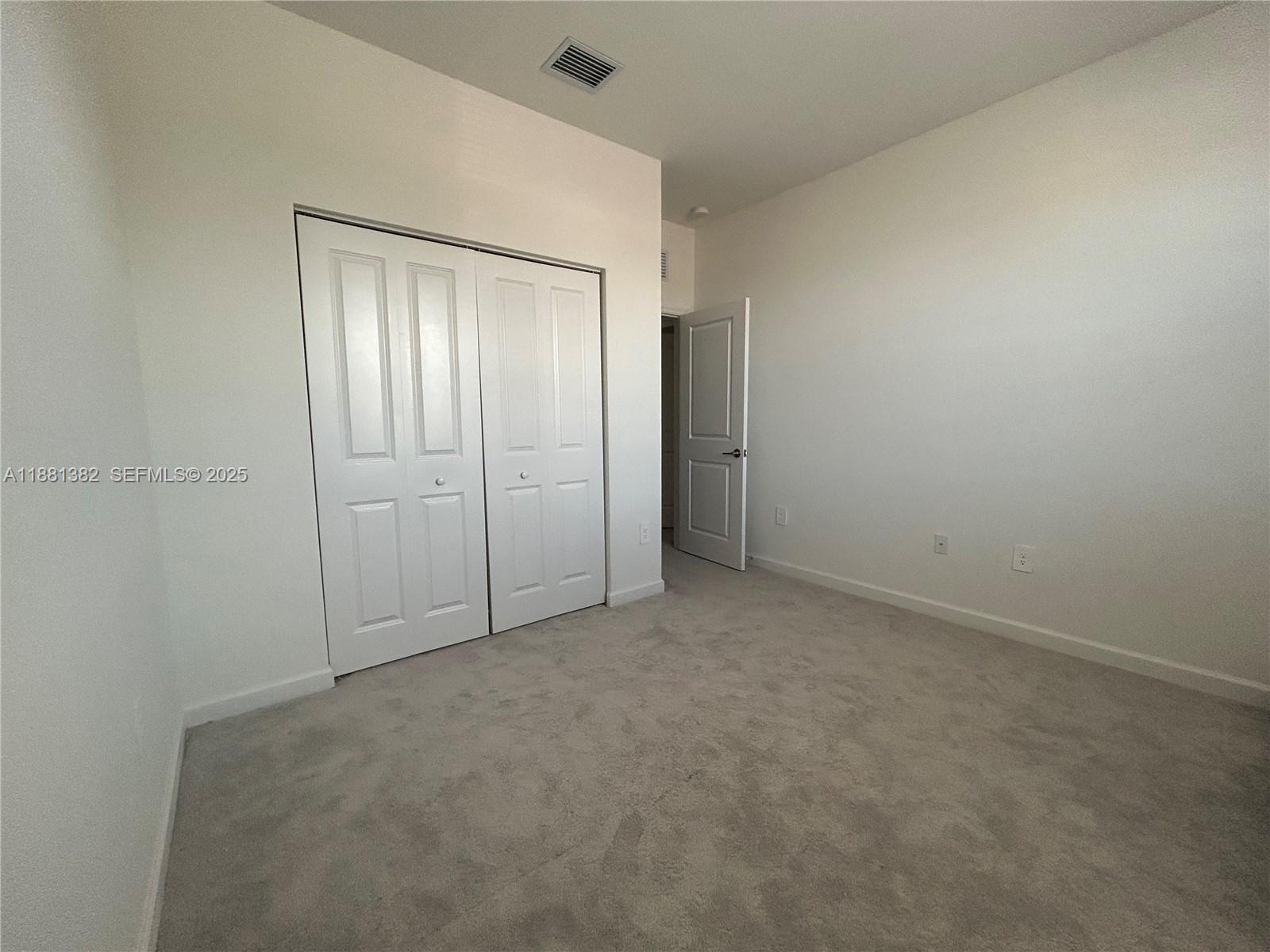 24030 Southwest 119th Place Homestead, FL 33032 - Photo 8 of 15 an empty room with closet area