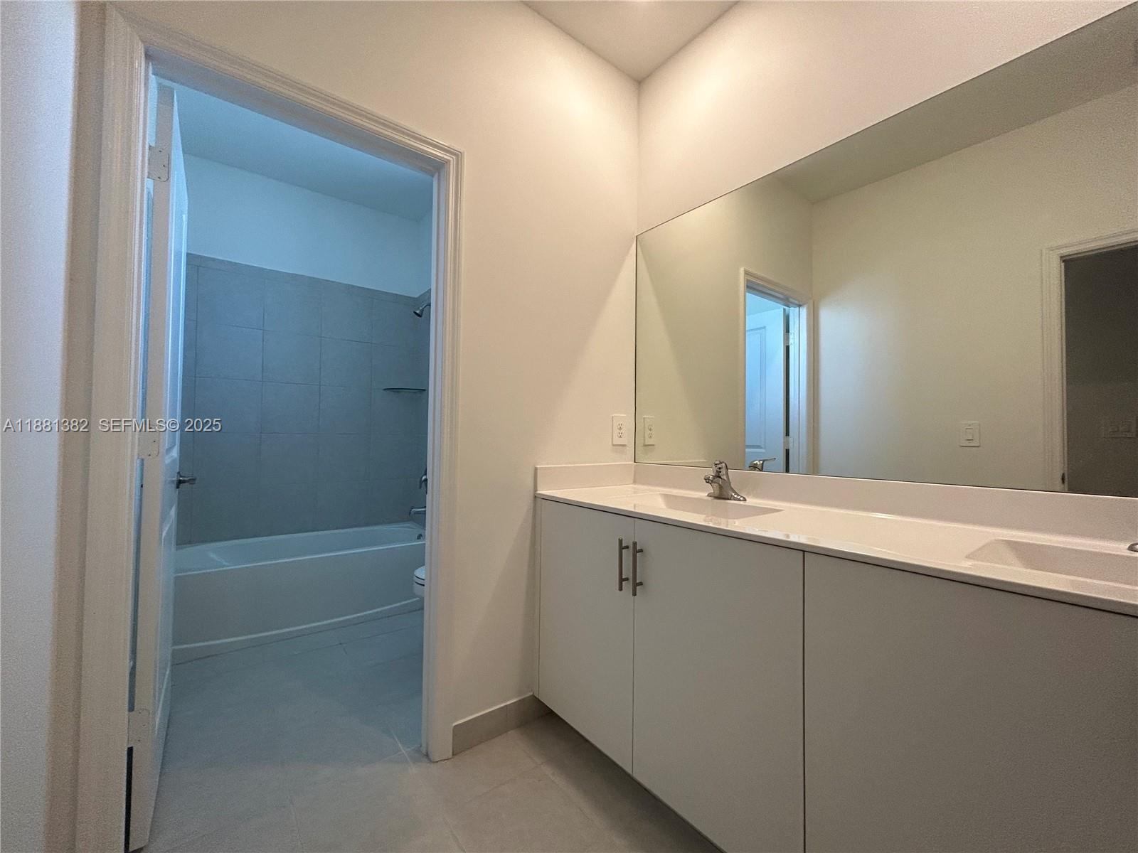 24030 Southwest 119th Place Homestead, FL 33032 - Photo 9 of 15 a bathroom with a bathtub and a sink