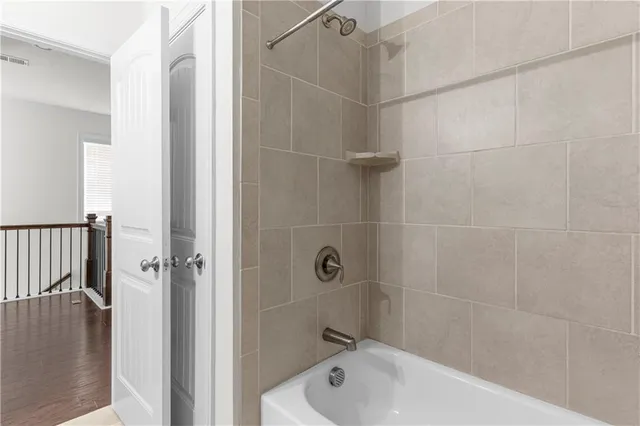 a bathroom with a bathtub and shower