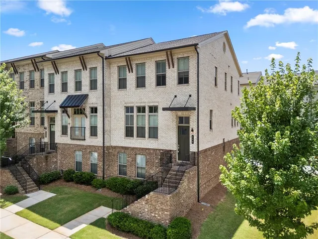 a large brick building with a yard in front of it