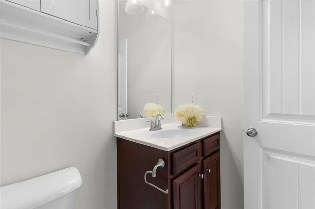 a bathroom with a sink toilet and mirror