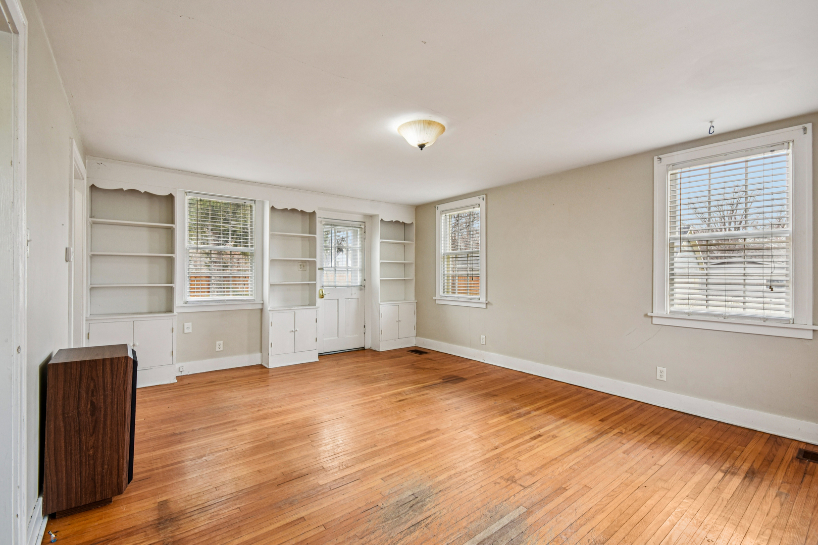 1246 Wauponsee Street Morris, IL 60450 - Photo 13 of 45 a view of an empty room with a window and wooden floor