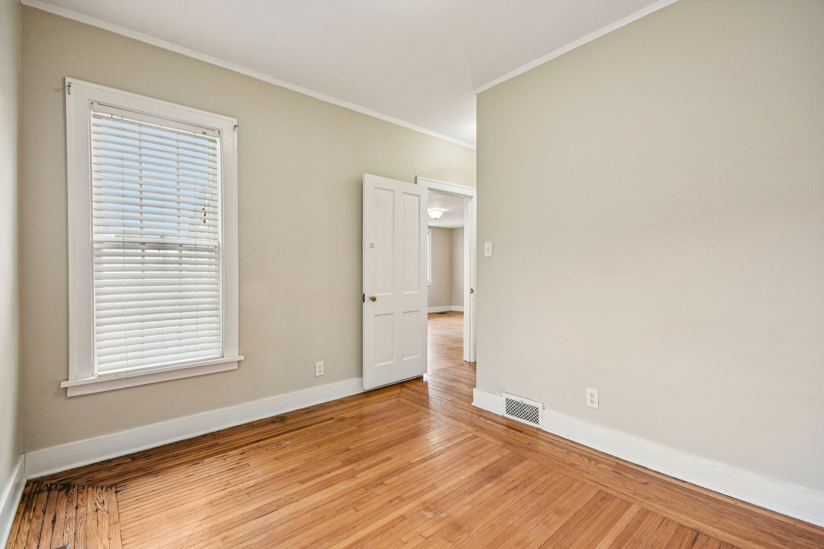 1246 Wauponsee Street Morris, IL 60450 - Photo 18 of 45 a view of an empty room with wooden floor and a window