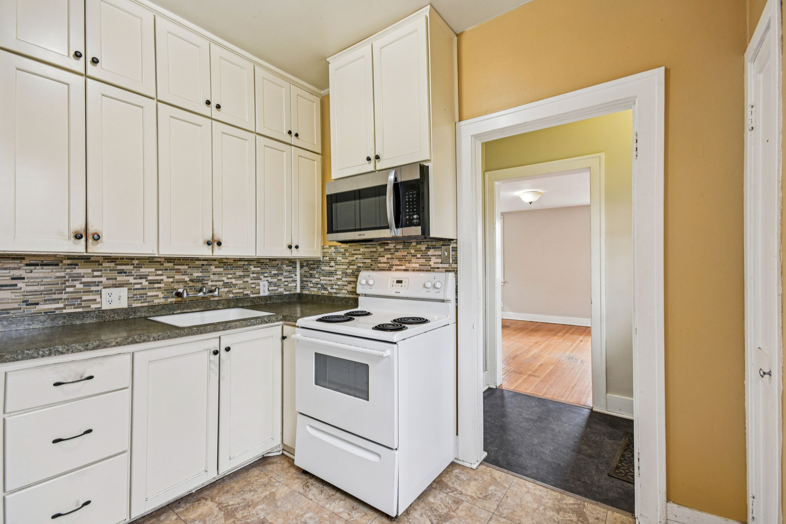 1246 Wauponsee Street Morris, IL 60450 - Photo 28 of 45 a kitchen with white cabinets and white appliances