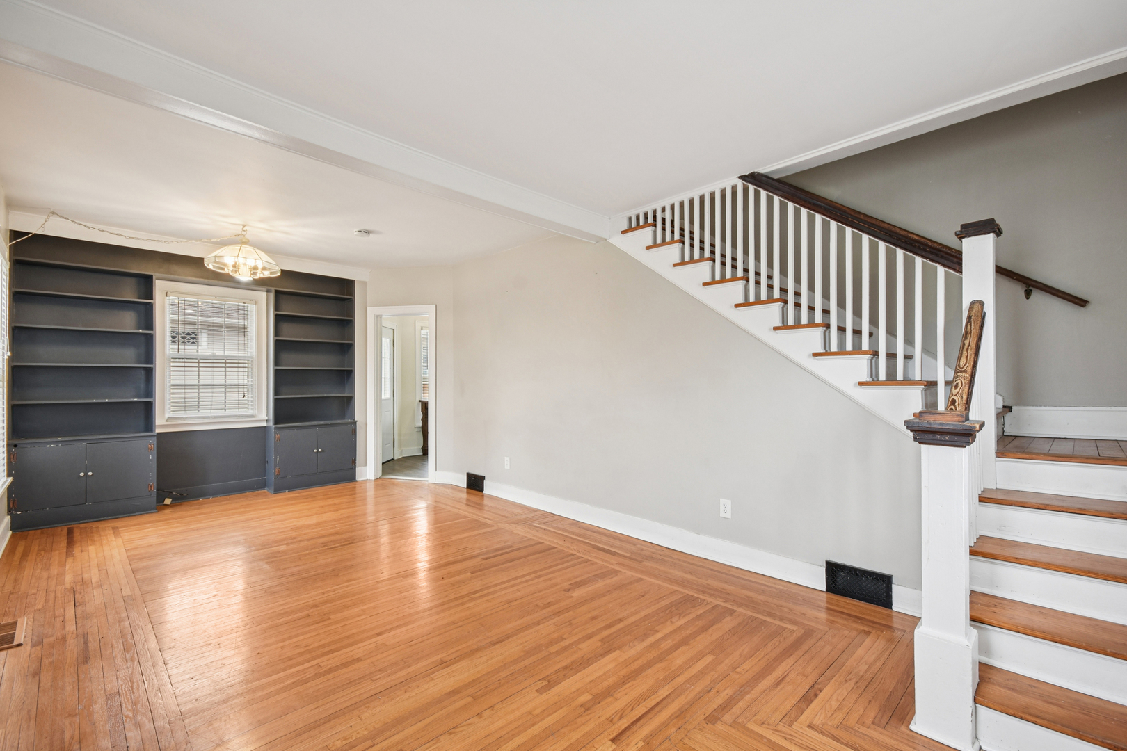 1246 Wauponsee Street Morris, IL 60450 - Photo 6 of 45 a view of an empty room with wooden floor and stairs