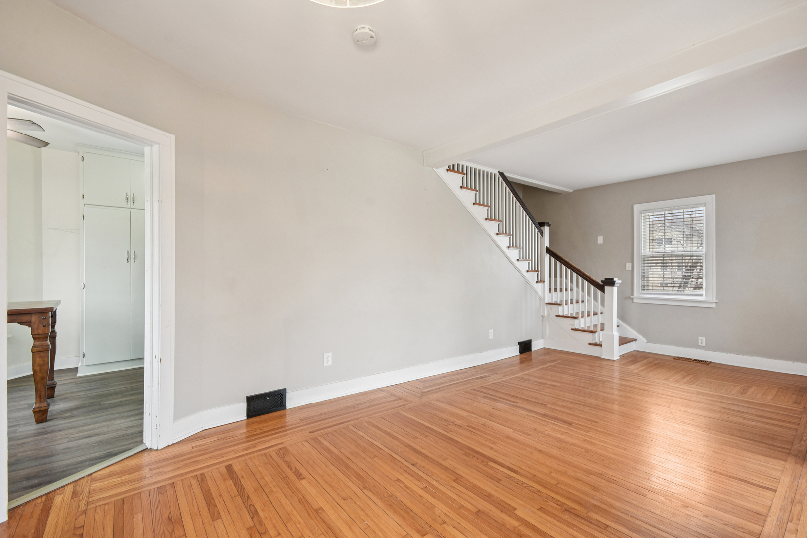 1246 Wauponsee Street Morris, IL 60450 - Photo 8 of 45 a view of an empty room with wooden floor and a window