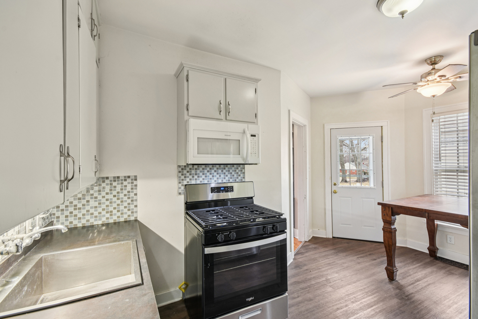 1246 Wauponsee Street Morris, IL 60450 - Photo 10 of 45 a kitchen with white cabinets and a stove