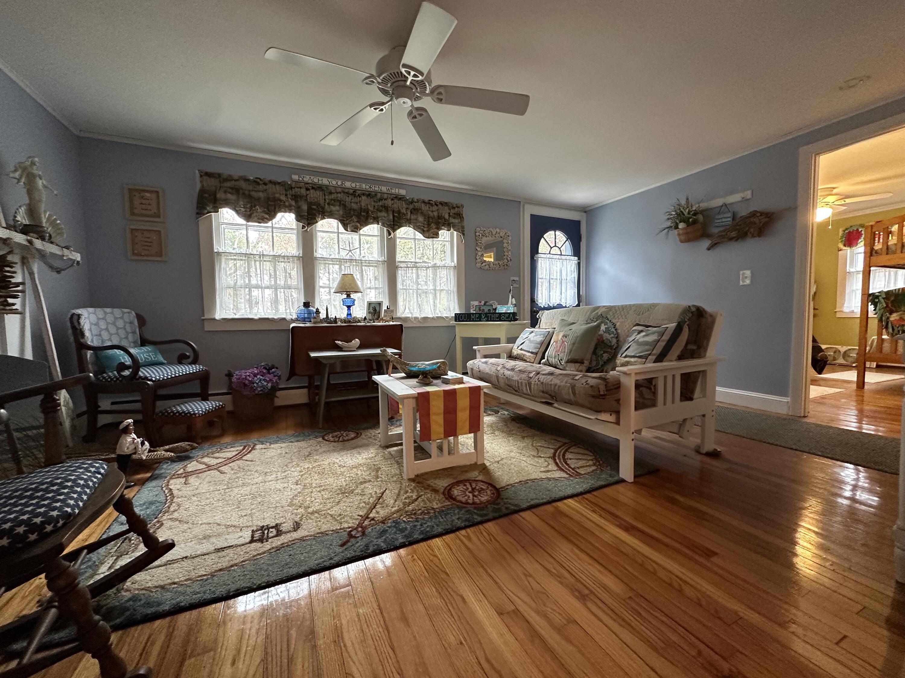 39 Naushon Road Dennis Port, MA 02639 - Photo 7 of 24 a living room with furniture fireplace and a large window