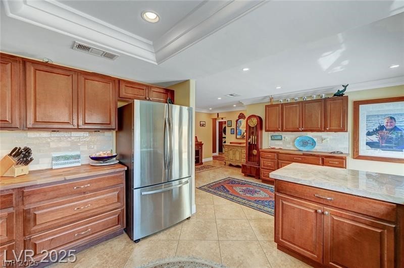 2410 Doherty Way Henderson, NV 89014 - Photo 24 of 63 Kitchen with freestanding refrigerator, crown molding, light countertops, recessed lighting, and decorative backsplash