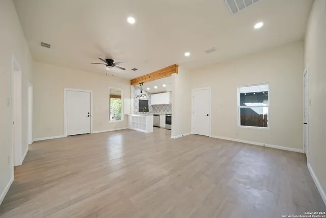 an empty room with a empty space and windows