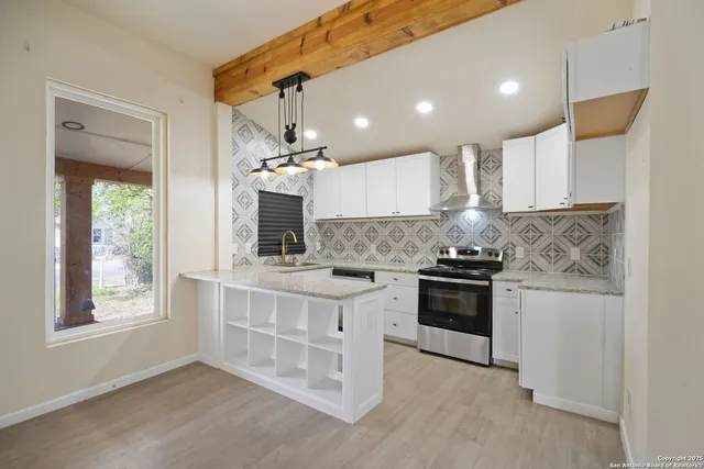 a kitchen with stainless steel appliances kitchen island granite countertop a stove and a sink
