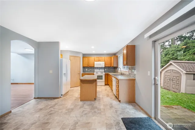 a kitchen with stainless steel appliances granite countertop a sink and a stove
