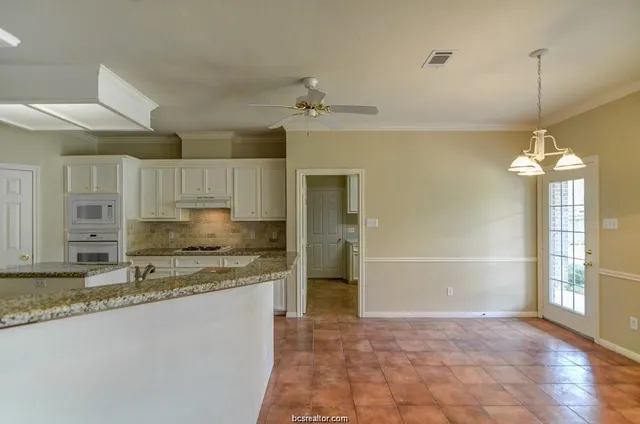 a view of a kitchen with a sink and chandelier