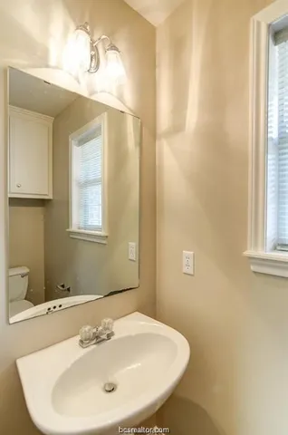 a bathroom with a sink and a mirror