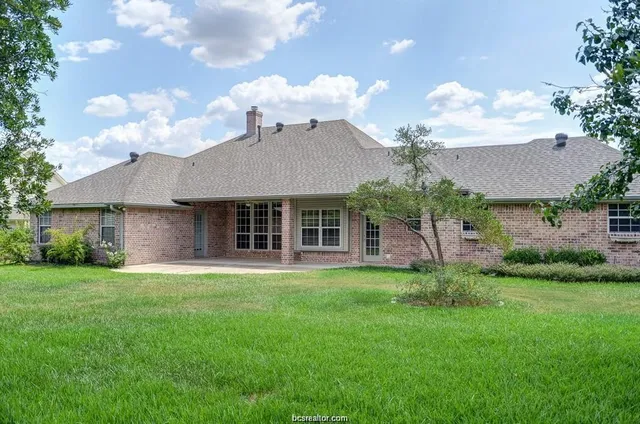a view of a house with a garden and plants