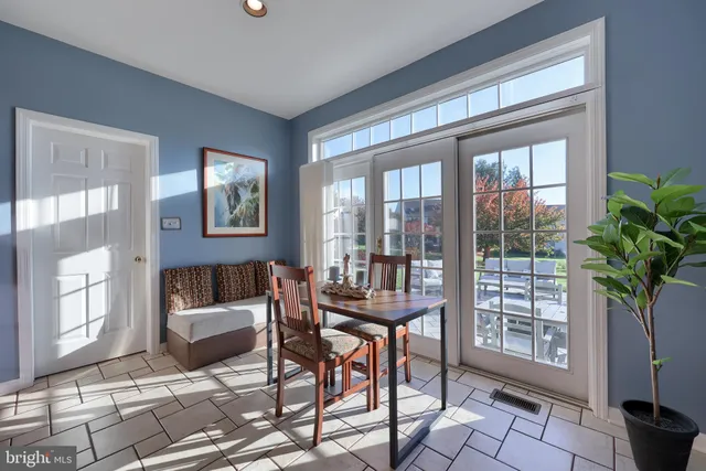 a large kitchen with stainless steel appliances granite countertop a stove refrigerator and a sink