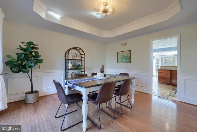 a bathroom with a bathtub and chandelier