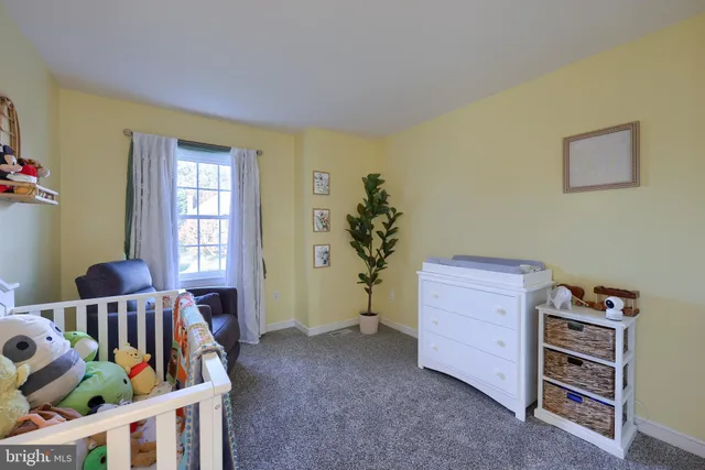 a living room with furniture a couch and a flat screen tv