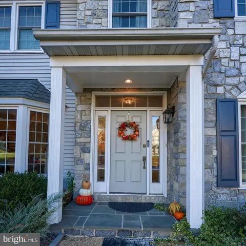 a living room with furniture large window and wooden floor
