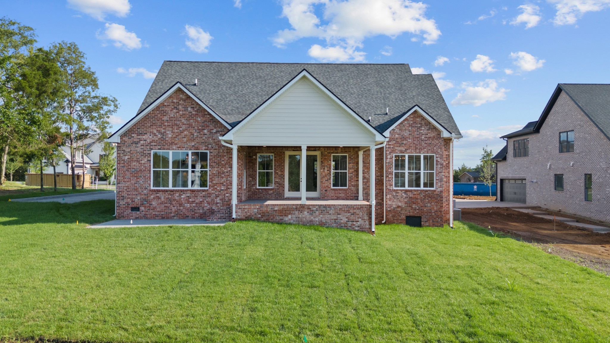 1107 Collin Drive Lebanon, TN 37087 - Photo 2 of 56 a front view of a house with a garden and trees