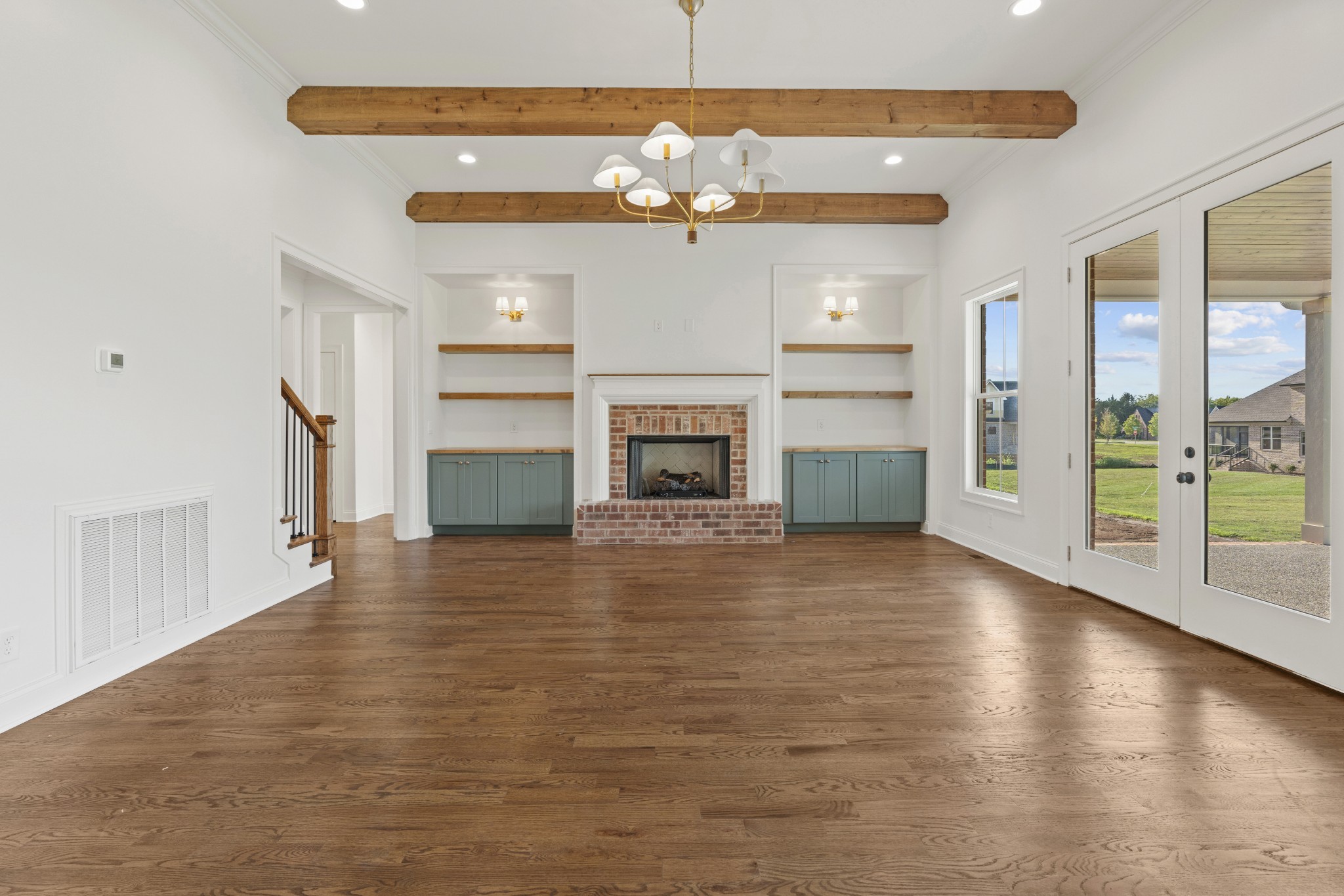 1107 Collin Drive Lebanon, TN 37087 - Photo 9 of 56 an empty room with wooden floor fireplace and windows