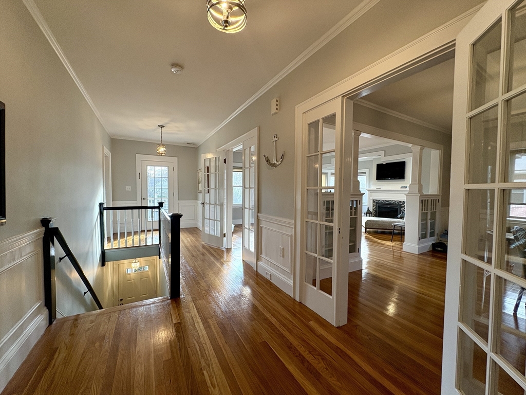 a view of a hallway view with wooden floor and staircase