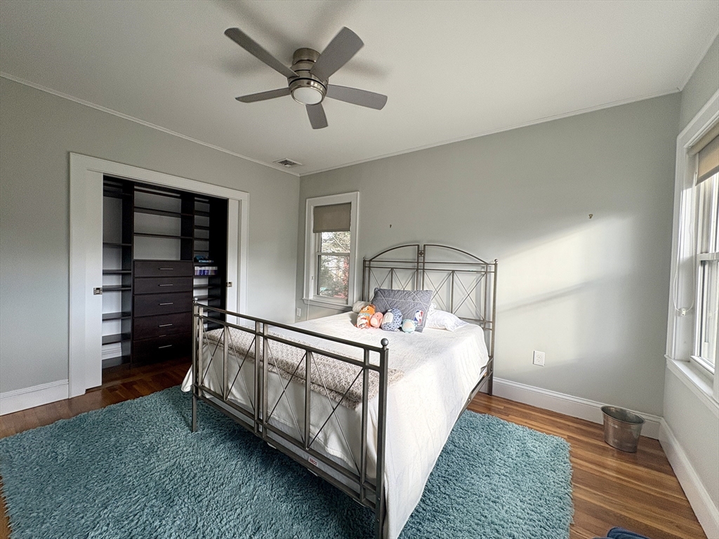 569 Commonwealth Avenue, Unit 2 Newton, MA 02459 - Photo 14 of 21 a bed sitting in a spacious bedroom next to a window