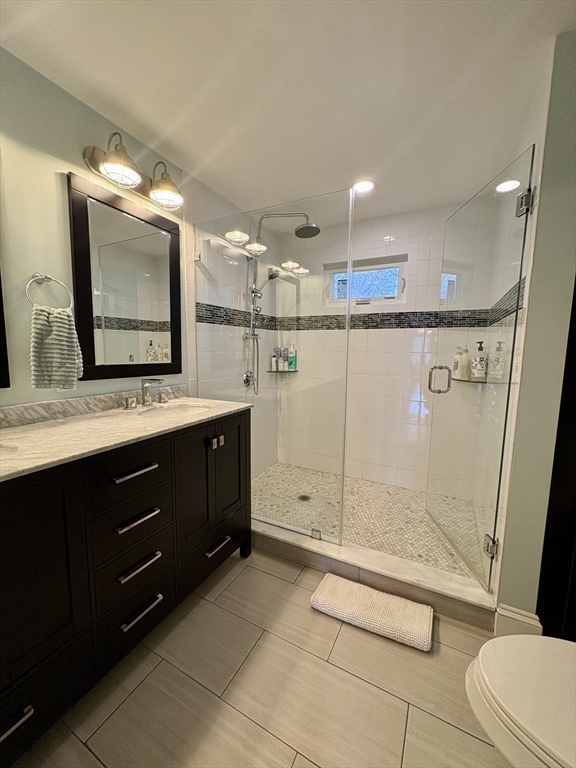 569 Commonwealth Avenue, Unit 2 Newton, MA 02459 - Photo 15 of 21 a bathroom with a double vanity sink mirror and toilet
