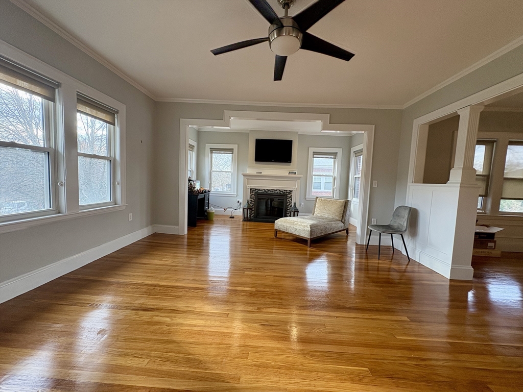 569 Commonwealth Avenue, Unit 2 Newton, MA 02459 - Photo 5 of 21 a living room with fireplace furniture and a wooden floor