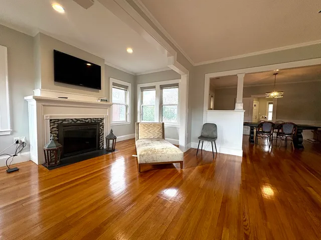 a living room with furniture fireplace and flat screen tv