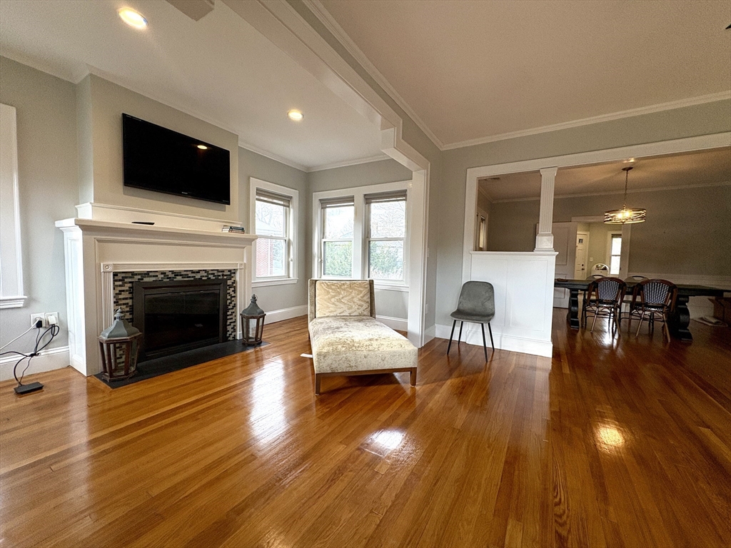 569 Commonwealth Avenue, Unit 2 Newton, MA 02459 - Photo 6 of 21 a living room with furniture fireplace and flat screen tv