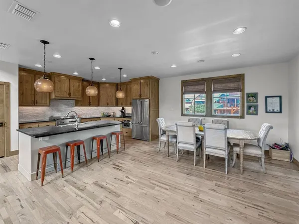 a large kitchen with a table and chairs in it