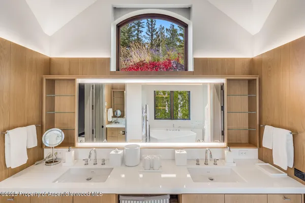 a bathroom with a double vanity sink and a mirror