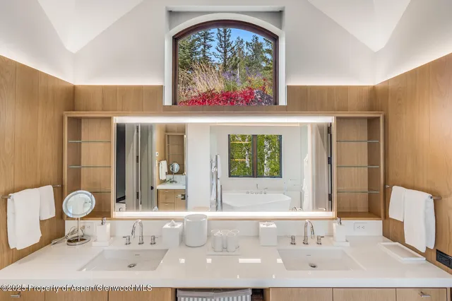 a bathroom with a double vanity sink and a mirror