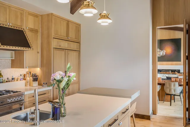 a kitchen with a table and chairs in it