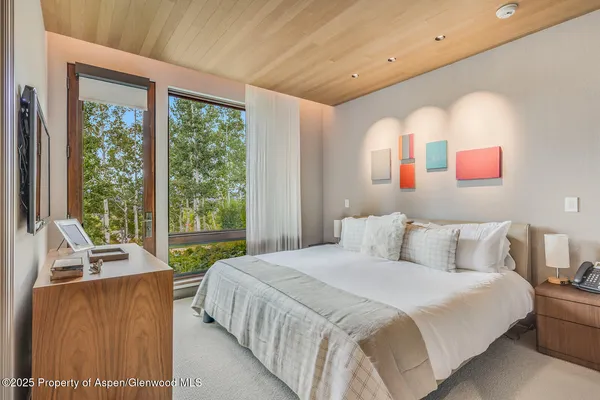 a bedroom with a bed and a television