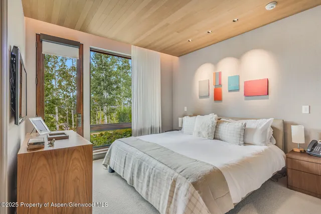 a bedroom with a bed and a television