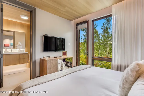 a bathroom with a sink double vanity granite tub and shower
