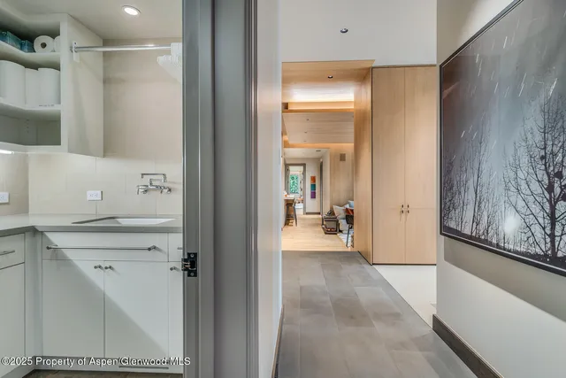 a view of a room with a large window and chairs