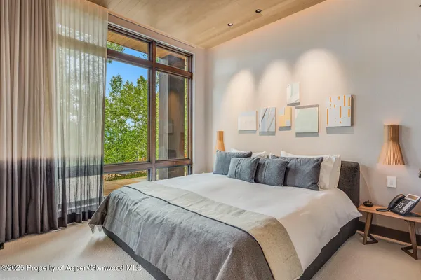 a view of house with roof deck outdoor seating and green space