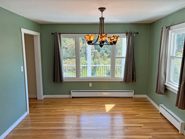 a view of an entryway with wooden floor