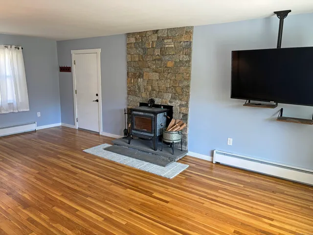 a bathroom with a granite countertop toilet and a sink