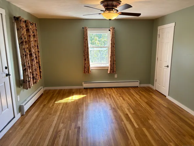 a view of room with window and wooden floor