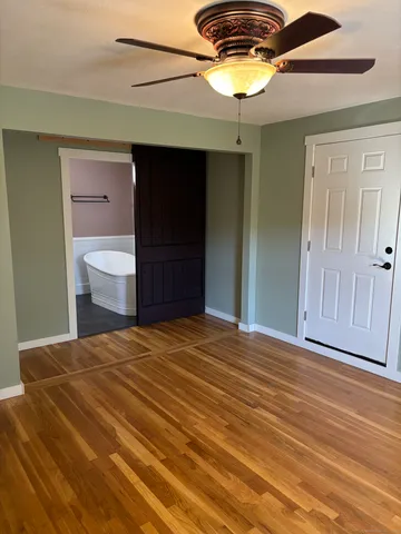 a view of a room with wooden floor